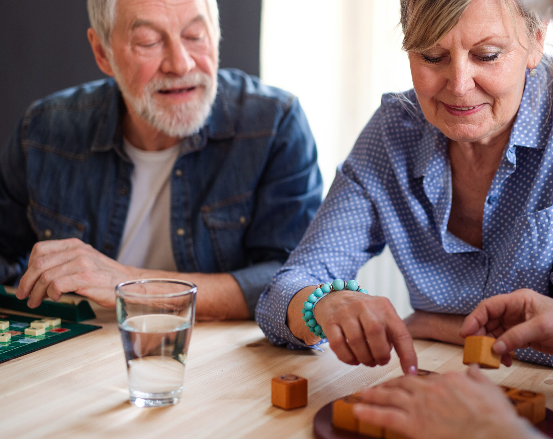 Group of Group of senior people sitting at the table in community center club, playing board games.