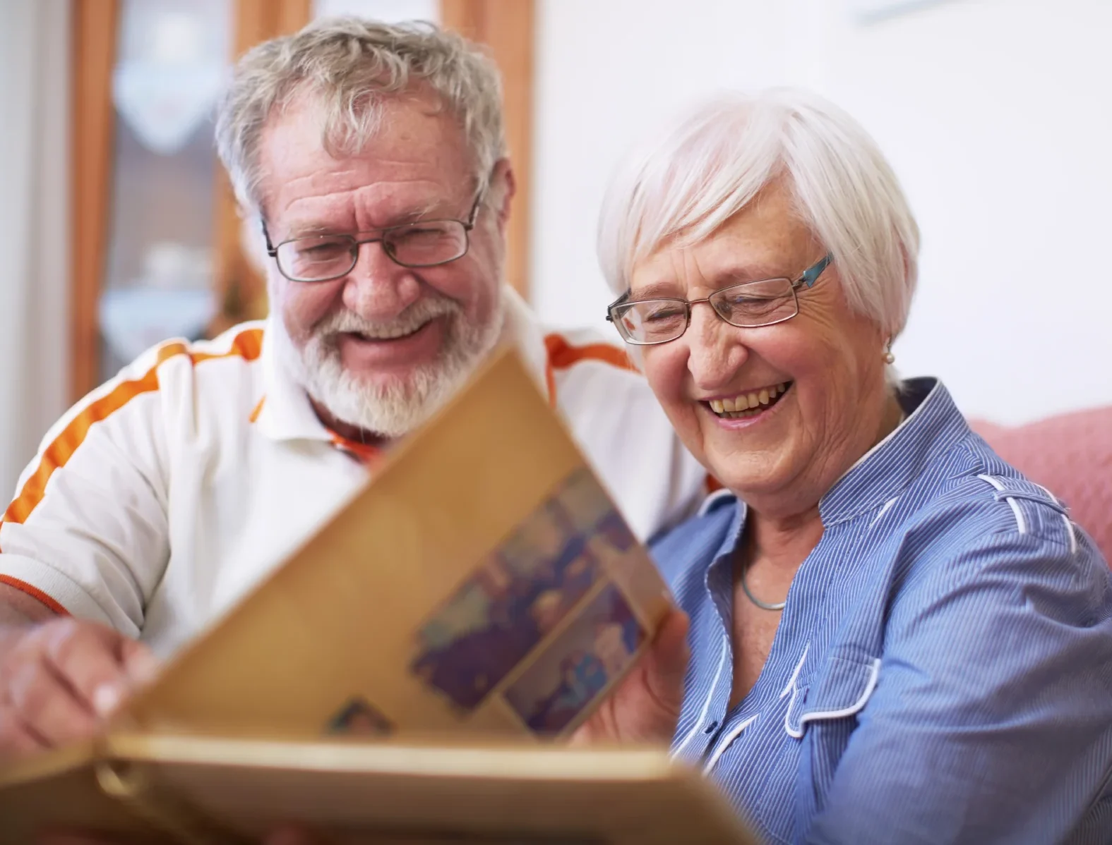 Senior Couple Looking At Photo Album