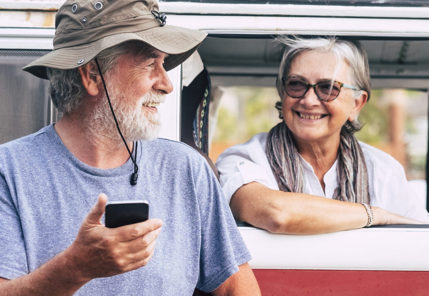 Senior couple traveling in a vintage van